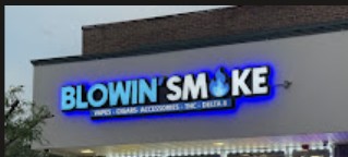 Blow'n Smoke storefront sign at night